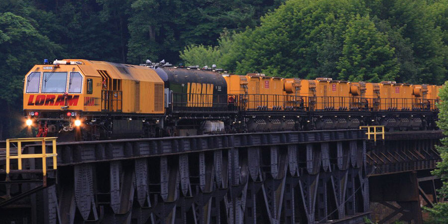 LORAM carts driving through wooded area